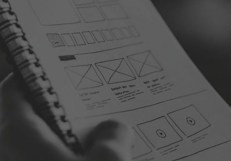 Image showing a website wireframe being sketched on a notepad