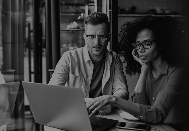 Graphic showing a man and a woman having a discussion looking at a laptop screen.